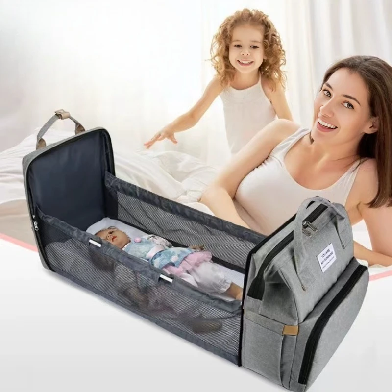woman next to her unfolded diaper bag rucksack backpack